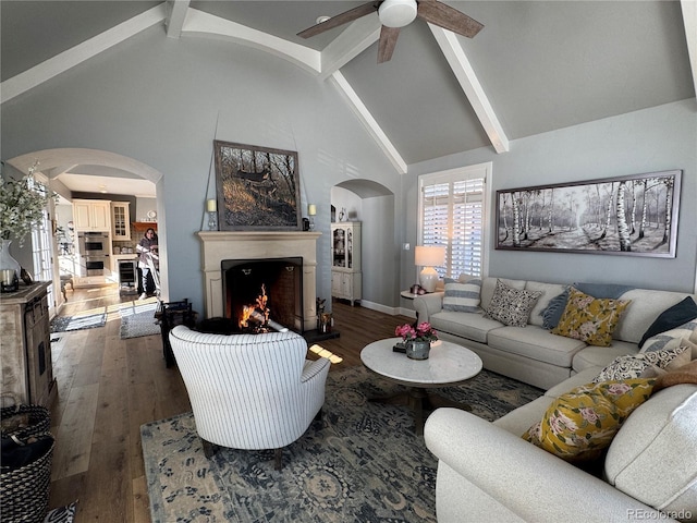 living room featuring beamed ceiling, ceiling fan, high vaulted ceiling, and dark hardwood / wood-style flooring