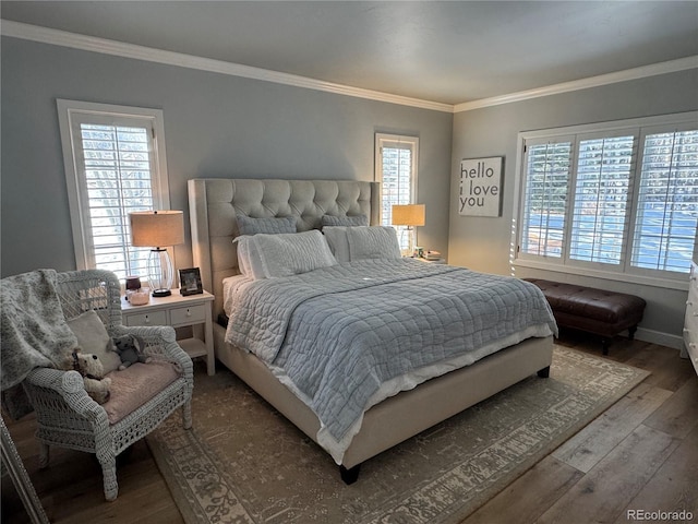 bedroom featuring multiple windows, hardwood / wood-style floors, and ornamental molding