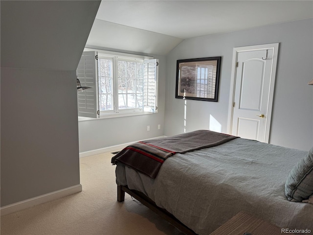 carpeted bedroom featuring lofted ceiling