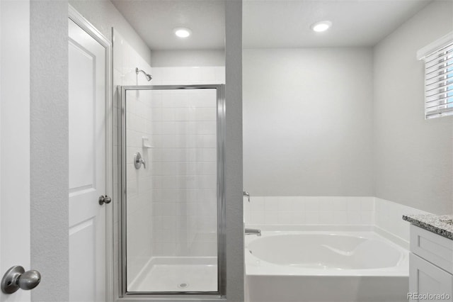 7322 Green River Ave, Frederick, CO 80530 - bathroom featuring a shower stall, a garden tub, vanity, and recessed lighting