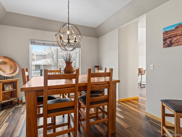 dining area featuring dark wood-style floors, baseboards, and a chandelier