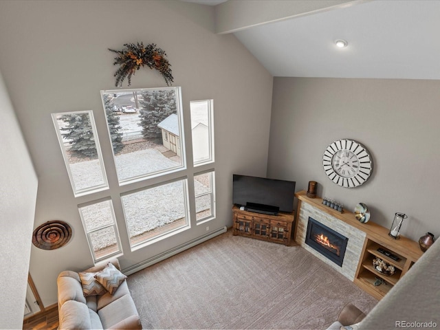 living room featuring lofted ceiling with beams, a baseboard heating unit, light colored carpet, and a glass covered fireplace