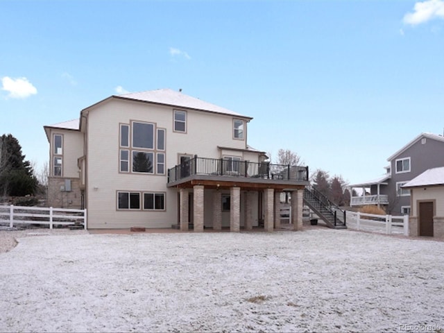 back of property featuring stairway, fence, and a wooden deck