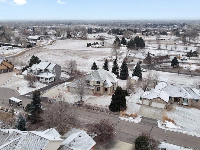 snowy aerial view with a residential view