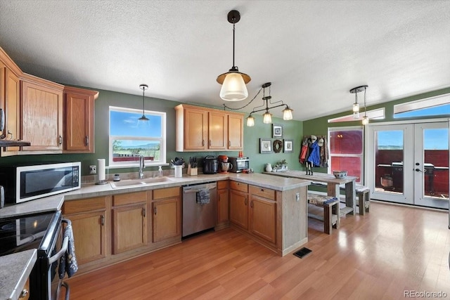 3316 Carlson Rd, Rye, CO 81069 - kitchen with stainless steel appliances, french doors, light countertops, a peninsula, and a textured ceiling