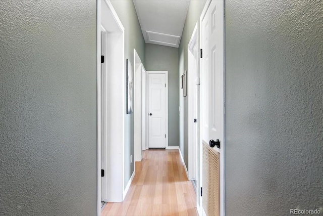 3316 Carlson Rd, Rye, CO 81069 - hall featuring light wood-style flooring, attic access, and a textured wall