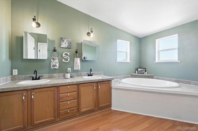 3316 Carlson Rd, Rye, CO 81069 - full bath with wood finished floors, a bath, double vanity, and vaulted ceiling