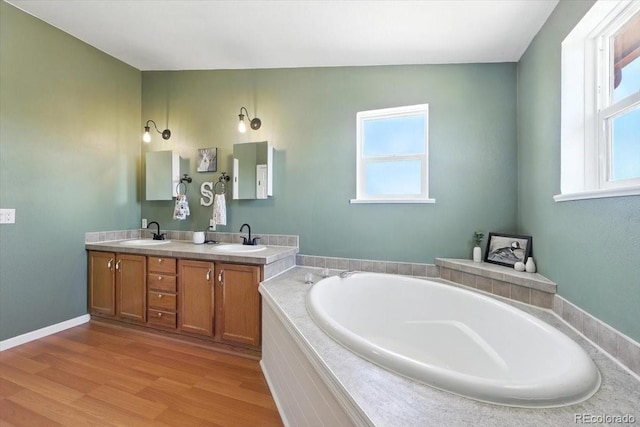 3316 Carlson Rd, Rye, CO 81069 - full bathroom with double vanity, a bath, and wood finished floors