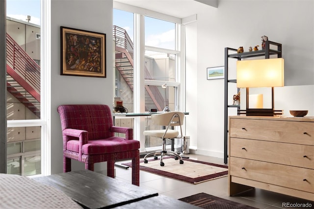 interior space featuring floor to ceiling windows and tile patterned flooring