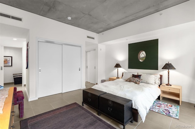 bedroom featuring tile patterned flooring and a closet