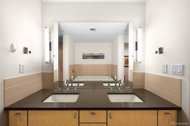 bathroom with vanity and a tub to relax in