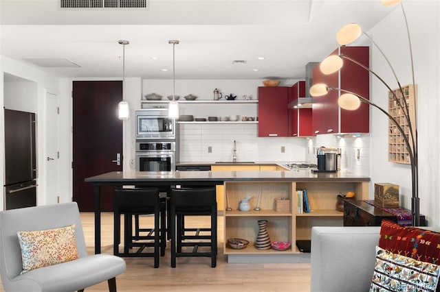 kitchen with stainless steel appliances, a sink, tasteful backsplash, visible vents, and open shelves