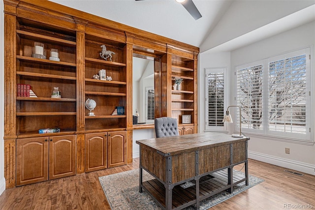 office space featuring vaulted ceiling, a ceiling fan, visible vents, and a wealth of natural light