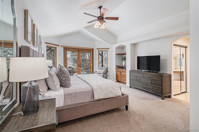 bedroom with arched walkways, light colored carpet, lofted ceiling, and access to exterior