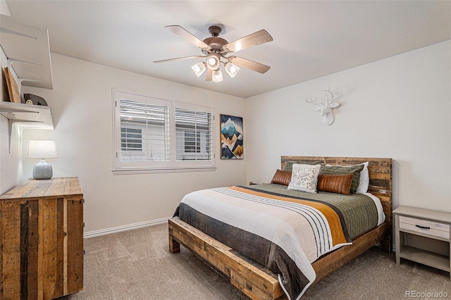 carpeted bedroom with baseboards and ceiling fan