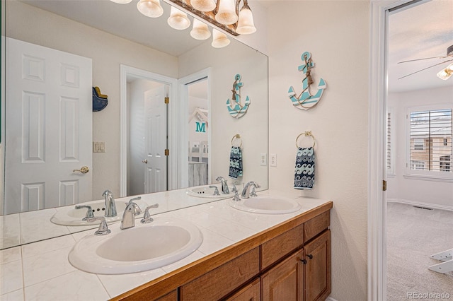 bathroom with a sink, ceiling fan, and double vanity