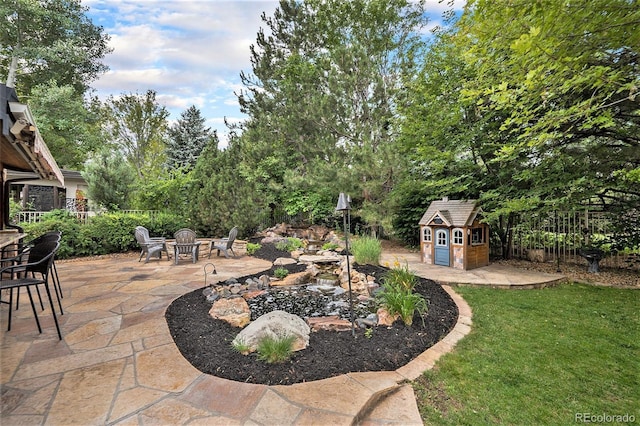 view of yard with an outdoor fire pit and a patio area