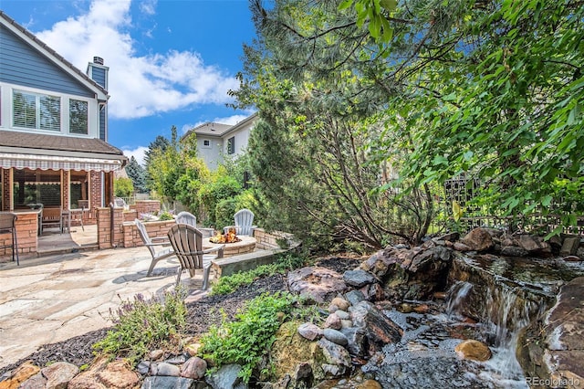 view of yard featuring a patio area and an outdoor fire pit