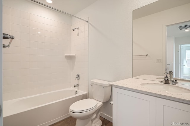 full bath with wood finished floors, toilet, bathtub / shower combination, and vanity