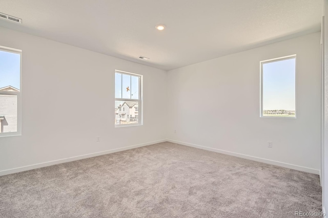 carpeted spare room with baseboards and recessed lighting