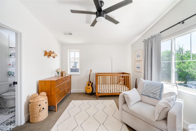 2571 S Cherokee St, Denver, CO 80223 - bedroom featuring light colored carpet, a nursery area, a ceiling fan, and connected bathroom