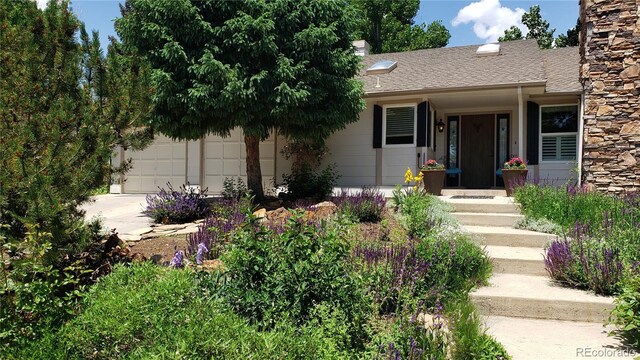 5298 Pony Creek Cir, Colorado Springs, CO 80919 - view of front of home with a garage, a shingled roof, and driveway
