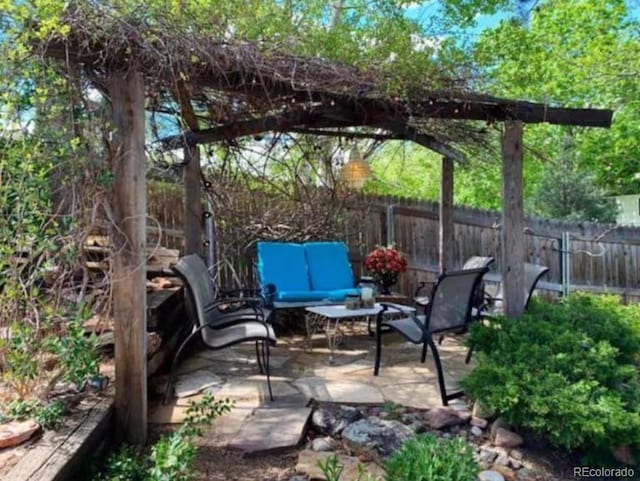 5298 Pony Creek Cir, Colorado Springs, CO 80919 - fenced backyard with an outdoor hangout area and a patio area