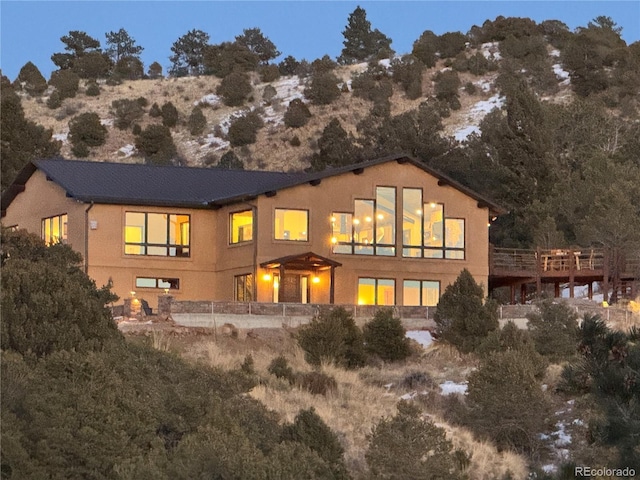 back house at dusk with a mountain view