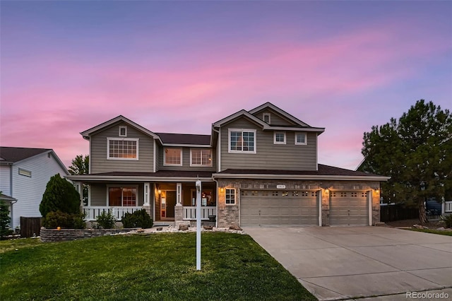 view of front of home with a porch, a garage, and a lawn