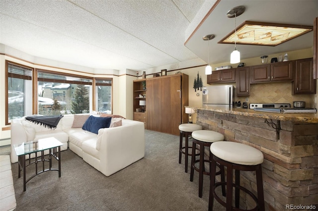 carpeted living room with a baseboard heating unit and a textured ceiling