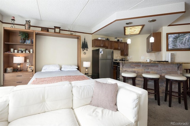 bedroom featuring light colored carpet, a textured ceiling, freestanding refrigerator, and lofted ceiling