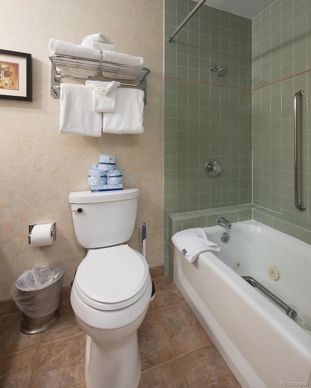 full bath with tile patterned floors, toilet, and a combined bath / shower with jetted tub