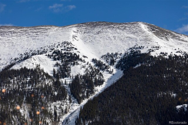 snowy aerial view with a mountain view