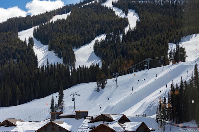 snowy aerial view featuring a view of trees