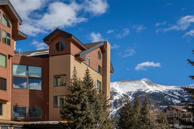 snow covered property with a mountain view