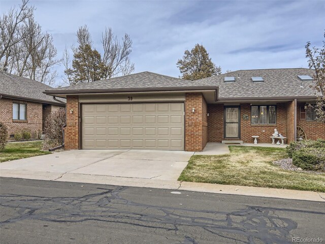 view of front of house featuring a garage and a front lawn