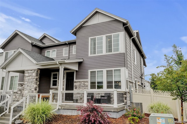 3765 W 88th Ct, Westminster, CO 80031 - back of house featuring stone siding and covered porch