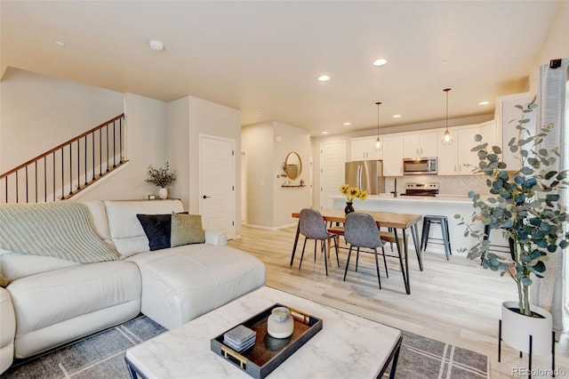 3765 W 88th Ct, Westminster, CO 80031 - living area with recessed lighting, light wood-style floors, stairs, and baseboards