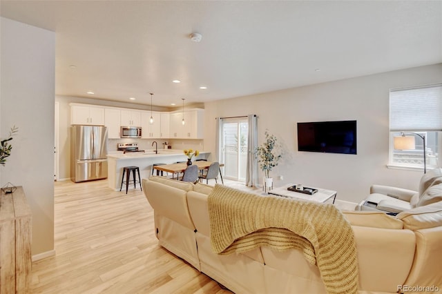 3765 W 88th Ct, Westminster, CO 80031 - living room featuring light wood-type flooring, recessed lighting, and baseboards