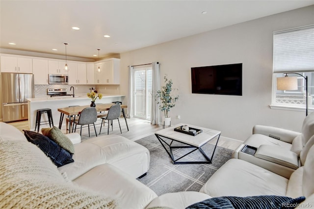 3765 W 88th Ct, Westminster, CO 80031 - living area with light wood finished floors, recessed lighting, and baseboards