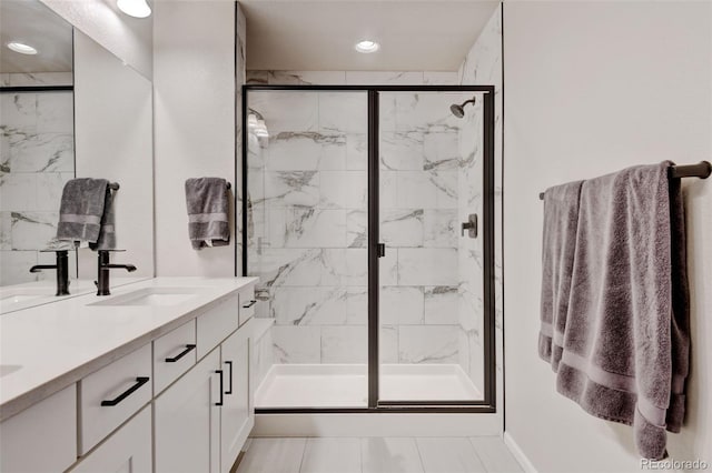 3765 W 88th Ct, Westminster, CO 80031 - bathroom with a marble finish shower, double vanity, and recessed lighting