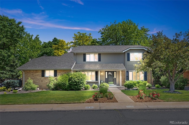 3726 E Nichols Ave, Centennial, CO 80122 - traditional-style home with a front yard, a porch, and brick siding