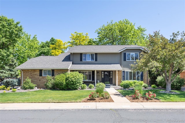 3726 E Nichols Ave, Centennial, CO 80122 - traditional home with a front yard, covered porch, and brick siding