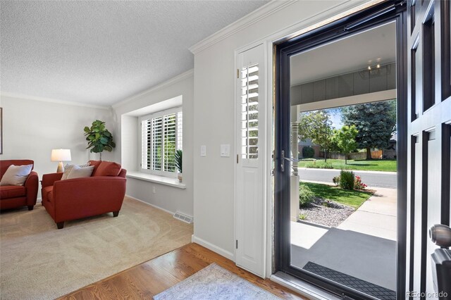 3726 E Nichols Ave, Centennial, CO 80122 - entrance foyer featuring wood finished floors, ornamental molding, a textured ceiling, and baseboards
