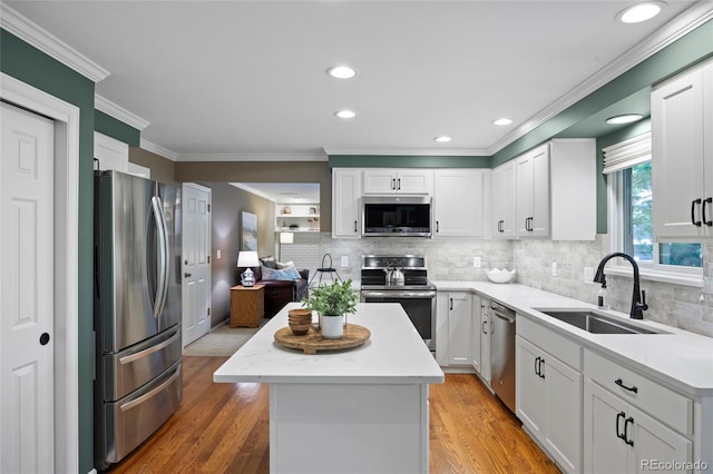 3726 E Nichols Ave, Centennial, CO 80122 - kitchen with appliances with stainless steel finishes, a sink, ornamental molding, a kitchen island, and tasteful backsplash