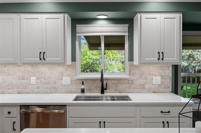 3726 E Nichols Ave, Centennial, CO 80122 - kitchen with stainless steel dishwasher, a sink, white cabinetry, and tasteful backsplash