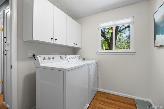 3726 E Nichols Ave, Centennial, CO 80122 - washroom with washing machine and dryer, wood finished floors, cabinet space, baseboards, and a textured ceiling