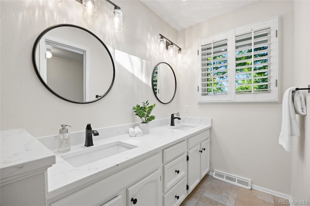 3726 E Nichols Ave, Centennial, CO 80122 - full bathroom featuring double vanity, baseboards, and a textured ceiling