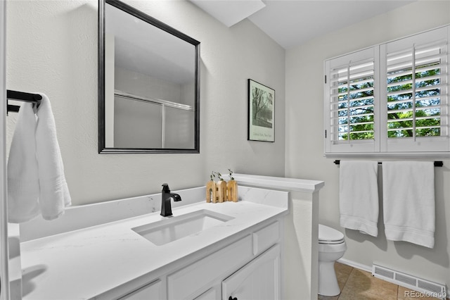3726 E Nichols Ave, Centennial, CO 80122 - full bathroom with toilet, vanity, tile patterned floors, a shower with shower door, and baseboards
