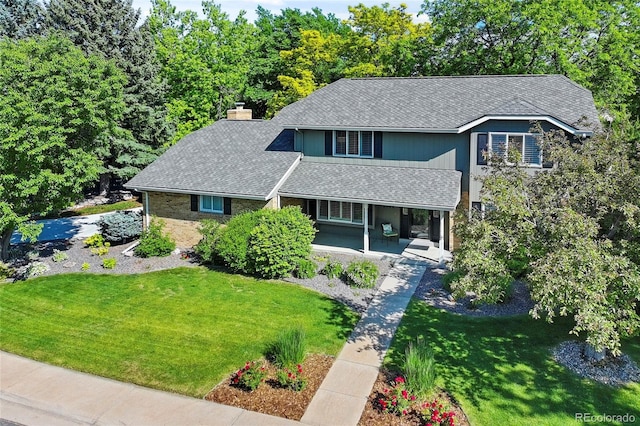 3726 E Nichols Ave, Centennial, CO 80122 - traditional home with covered porch, a front lawn, a shingled roof, and a chimney